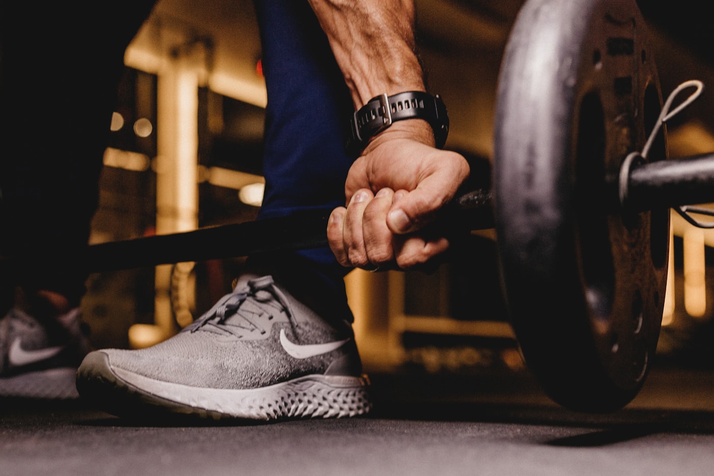 Close up of hand gripping barbell in gym